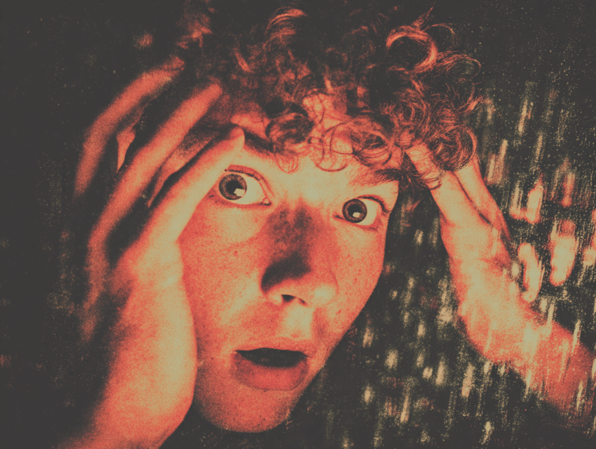 a man's closed up face full of fear